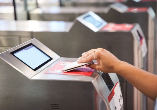 A female doing online payment with card in airport
