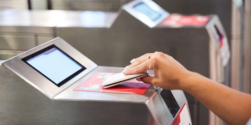 A female doing online payment with card in airport
